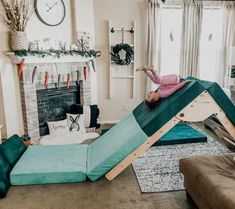 a woman laying on top of a slide in a living room