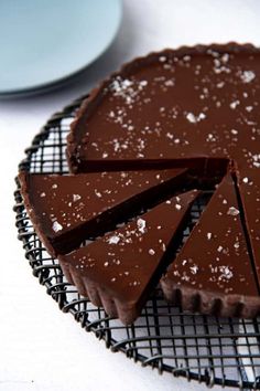 a chocolate tart sitting on top of a cooling rack