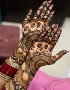 a woman's hands with hennap on it, showing the intricate design