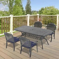 an outdoor dining set on a deck with blue chairs and table in the foreground