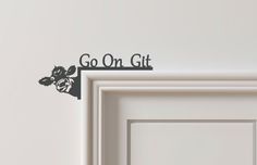 a sign that says go on git next to a door with an image of a dog