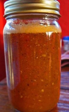 a glass jar filled with something on top of a wooden table