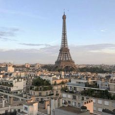 the eiffel tower towering over all of the buildings in paris, france at sunset