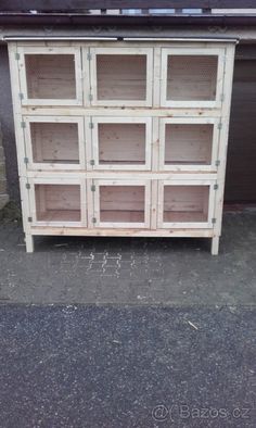 an old dresser is painted white and has glass doors on the top, along with metal grates