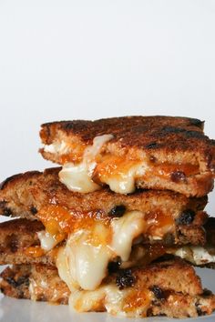 three grilled cheese and onion patties stacked on top of each other in front of a white background