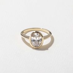 a gold ring with a white diamond in the center