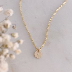 A dainty little 14k Gold Filled initial disc is hand stamped with your choice of initial in uppercase block font. The disc measures 8mm (1/4").  The initial disc comes on a delicate, but very strong, 14k Gold Filled chain.Beautifully packaged in our signature white and gold Eden Zoe gift box. Minimalist 14k Gold Hand Stamped Charm Necklace, Dainty Hand Stamped 14k Gold Charm Necklaces, Dainty 14k Gold Initials Charm Necklace, Minimalist Yellow Gold Hand Stamped Charm Necklace, Dainty Hand Stamped 14k Gold Necklace, Minimalist Everyday Round Initial Necklace, Everyday Monogram Initial Necklace, 14k Gold Hand Stamped Charm Necklaces With Round Pendant, Hand Stamped 14k Gold Round Pendant Charm Necklaces