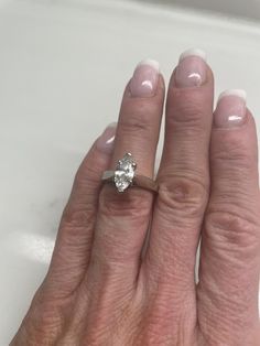 a woman's hand with a diamond ring on it