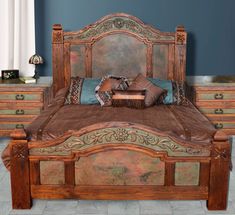 a large bed sitting in the middle of a room next to a dresser and mirror