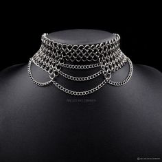 Handcrafted Stainless Steel Chainmail Choker This unique statement piece, features an open bottom half, connected by cascading chains. The chains bridge the open side and add an edgy touch by connecting the sides. This choker is an eye-catching accessory that adds a layer of sophistication & style to any outfit. Made from superior quality stainless steel, our products are durable, resilient and allergy friendly.  We also offer a lifetime repair warranty! *Terms & Conditions Apply Our unique fini Chainmail Choker, Chainmaille Jewelry Patterns, Chainmail Necklace, Chainmail Jewelry, Chain Maille Jewelry, Chain Mail, Fantasy Jewelry, Choker Necklaces, Jewelry Inspo