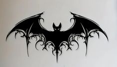 a black and white image of a bat with wings on it's back side