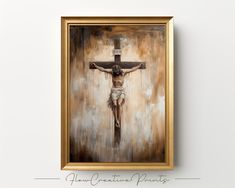 a painting of jesus on the cross in a gold frame hanging on a white wall