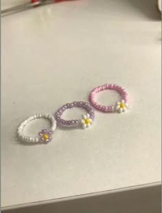 three beaded bracelets sitting on top of a table