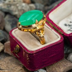 This beautiful ring features an oval cabochon cut chrysoprase with a detailed gallery and open gold work on the shoulders. It is crafted in 18k yellow gold and is currently a size 7.5. The ring shows a nice patina. Antique Gold Emerald Ring With Oval Cabochon, Antique Emerald Ring In Gold With Oval Cabochon, Antique Gold Emerald Cabochon Ring, Antique Yellow Gold Emerald Cabochon Ring, Antique Yellow Gold Cabochon Emerald Ring, Yellow Gold Emerald Chrysoprase Cabochon Ring, Vintage Green Oval Opal Ring, Heirloom Green Oval Opal Ring, Gold Oval Chrysoprase Emerald Ring