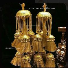 several gold tassels are stacked on top of each other in front of a black background