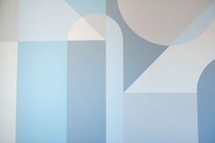 an abstract blue and white wallpaper with curved shapes