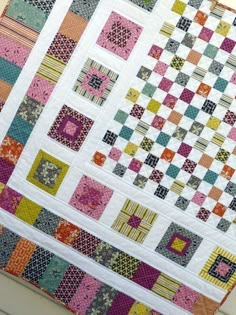 a colorful quilt is hanging on the wall