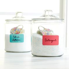 two glass jars with magnets and labels on them