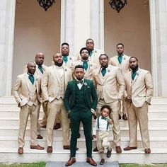 a group of men standing next to each other in front of a building with stairs