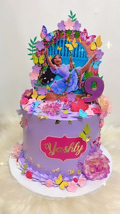 a birthday cake decorated with an image of a woman on the top and butterflies around it