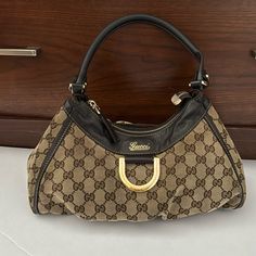 It Is In Used Condition And All The Flaws Have Been Shown In The Pictures . Gucci Shoulder Bag In Monogram Canvas With Gold-tone Hardware, Gucci Monogram Canvas Shoulder Bag With Gold-tone Hardware, Gucci Bag With Branded Hardware And Double Handle, Designer Hobo Bag With Gold-tone Hardware, Gucci Monogram Canvas Shoulder Bag With Branded Hardware, Gucci Brown Shoulder Bag With Detachable Handle, Gucci Hobo Shoulder Bag With Gold-tone Hardware, Brown Gucci Shoulder Bag With Detachable Handle, Gucci Shoulder Bag With Gold-tone Hardware For Shopping