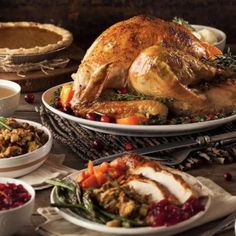 a turkey sitting on top of a table next to other dishes