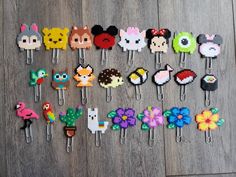 a collection of cartoon character hair clips on a wooden floor next to a pair of scissors