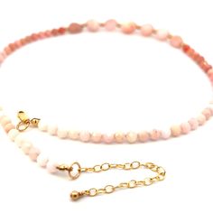 This is an exquisite Peruvian Pink Opal necklace with 14k gold filled lobster clasp and extender chain. Pink Peruvian Opals are rare and especially rare with few to no dark spots. The natural, free form nuggets and faceted beads on this necklace are A+ quality with few imperfections. The small faceted beds are arranged in a slight ombre pattern and range in color from light pink and peach/pink to white. The chain is adjustable from about 17-19” and has a lobster clasp. This would be a treasured Dainty Hand-strung Necklace As A Gift, Adjustable 14k Gold Filled Gemstone Necklace, Dainty Hand-strung Necklace For Gift, Adjustable Yellow Gold Necklace With Gemstone Beads, Dainty Hand-strung Necklaces For Gifts, Dainty Hand-strung Necklaces With Round Beads, Adjustable 14k Gold Filled Necklaces With Natural Stones, Adjustable 14k Gold Filled Necklace With Natural Stones, Adjustable Single Strand Yellow Gold Beaded Necklace