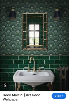 a bathroom sink sitting under a mirror next to a green tiled wall with gold accents