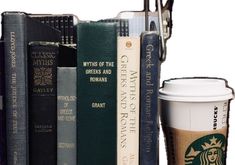 a cup of coffee sitting next to books on a shelf with glasses and eyeglasses