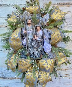 a wreath with two figurines on top of it