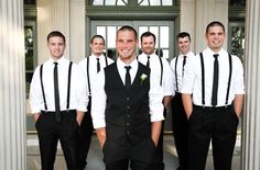 a group of young men standing next to each other in front of a building with columns