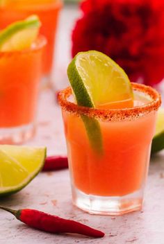 two glasses filled with watermelon margaritas and garnished with lime slices