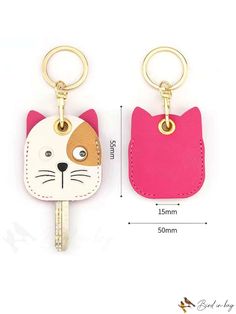 the key chain has a cat face on it and is attached to a leather case