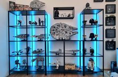 a display case filled with star wars toys and figurines on top of shelves