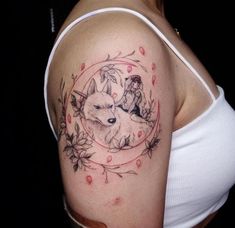 a woman's arm with a tattoo on it and an image of a wolf