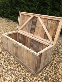 a wooden box sitting on top of gravel