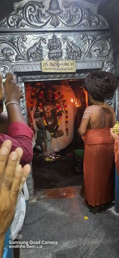 people standing in front of a small shrine