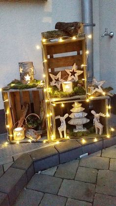 three wooden boxes with christmas lights on them