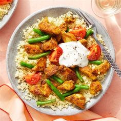 two plates of food with rice and vegetables