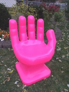 an inflatable hand sitting on top of a lawn