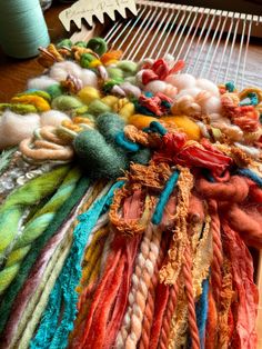 many different colored yarns are laid out on a weaving loom