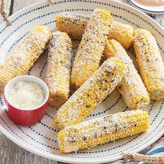 grilled corn on the cob with butter and seasoning sitting on a plate