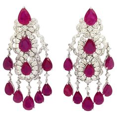 Ruby 18.73 carats and Diamond 4.12 carats Earrings set in 18K White Gold Settings Width: 2.5 cm Length: 5.0 cm Total Weight: 23.91 grams "We first opened doors in 1980 when it was then situated in the vicinity of the Victory Monument; a small and modest storefront with a couple of counters. From its humble beginnings to where it stands today, our company has proven its abilities as a jeweler. Since the beginning, we have been supplying fine quality pieces to dealers, wholesalers and customers wo Oval Diamond Earring, Gold Ruby Earrings, Gold Oval Earrings, Diamond Gold Earrings, White Gold Drop Earrings, Ruby Jewellery, Earrings Multiple, Yellow Gold Diamond Earrings, Round Diamond Earrings