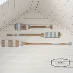 three wooden paddles mounted to the wall in a room