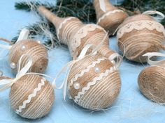 several ornaments are arranged on a blue surface with white ribbons and twine around them