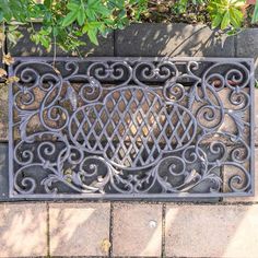 a metal grate sitting on top of a sidewalk