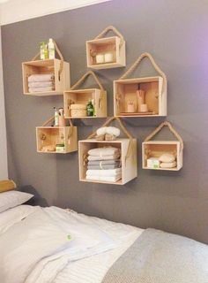 some shelves are hanging on the wall above a bed