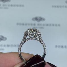 a close up of a person holding a diamond ring