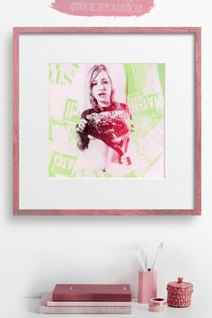 a pink and green photo hanging on the wall